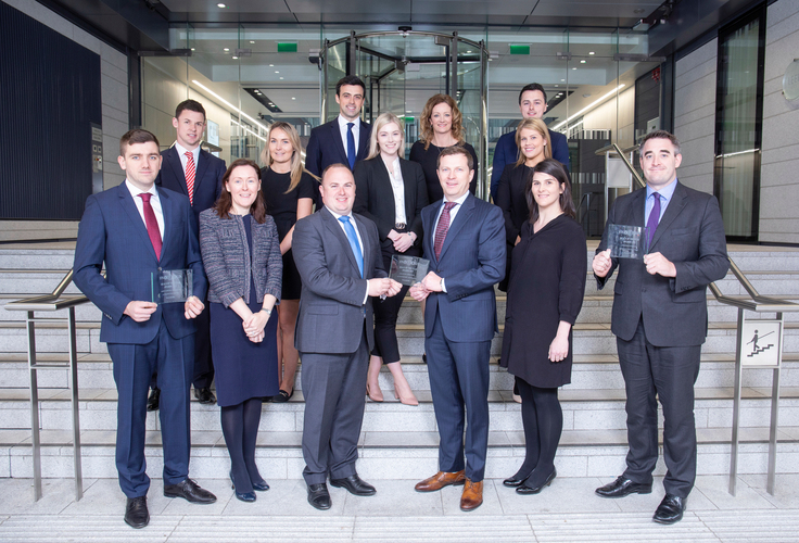 Some of Walkers' Finance and Capital Markets team pictured with the team's three Finance Dublin Deals of the Year 2019 including: Deal of the Year Financial Services, Securitisation: Auto Loans - Kimi 7: Finnish Auto Loan Securitisation - Santander Consumer Finance; Deal of the Year Debt Capital Markets: Auto Securitisation - Citizen Irish Auto Receivables Trust 2018 - First Citizen; and a further Deal of the Year Debt Capital Markets: Repackaging (Carbon Offsets) - Tramontana Asset Management. Walkers Asset Finance team won a fourth award for Deal of the Year Aviation Finance: Joint Venture Platform - Airborne Capital/AltitudeOne Aviation<br />
Front row, from left: Paddy Rath, Of Counsel; Noeleen Ruddy, partner; Andrew Traynor, partner; Garry Ferguson, managing partner; Muireann Nic Dhonncha, senior associate; Matt Hedigan, partner;<br />
Middle row, from left: Patrick Kennedy, Trainee Solicitor; Clare Mannion, Associate; Aisling Ni Bhriain, Trainee Solicitor; Nessa Kilgallen, Trainee Solicitor;<br />
Back row, from left: Timothy Fetherston, Associate; Therese Redmond, Head of Listing Services; Mark O'Reilly, Trainee Solicitor